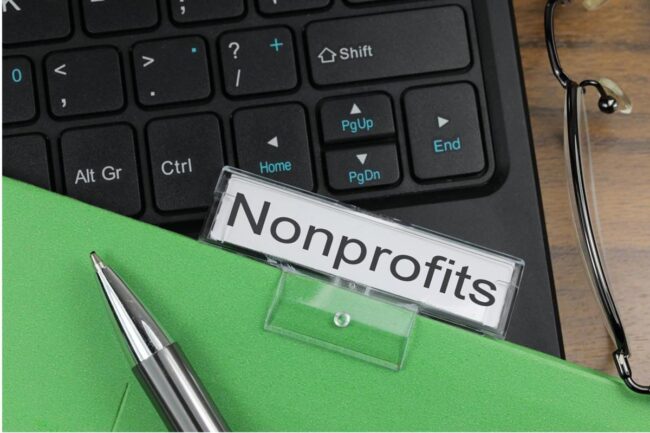 nonprofits A keyboard, pen and green folder with the title Nonprofits