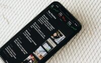 image of mobile phone displaying news headlines